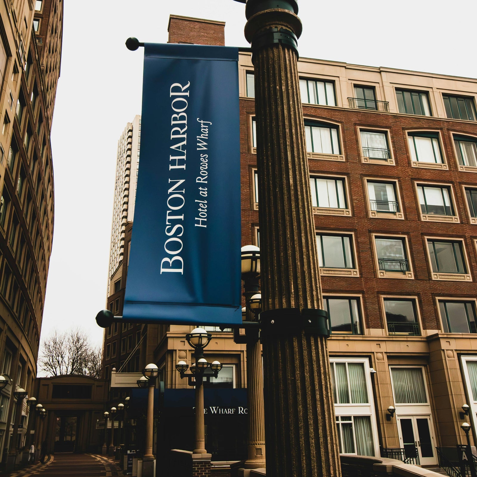Blue Boston Harbor street pole banner on a decorative downtown light pole