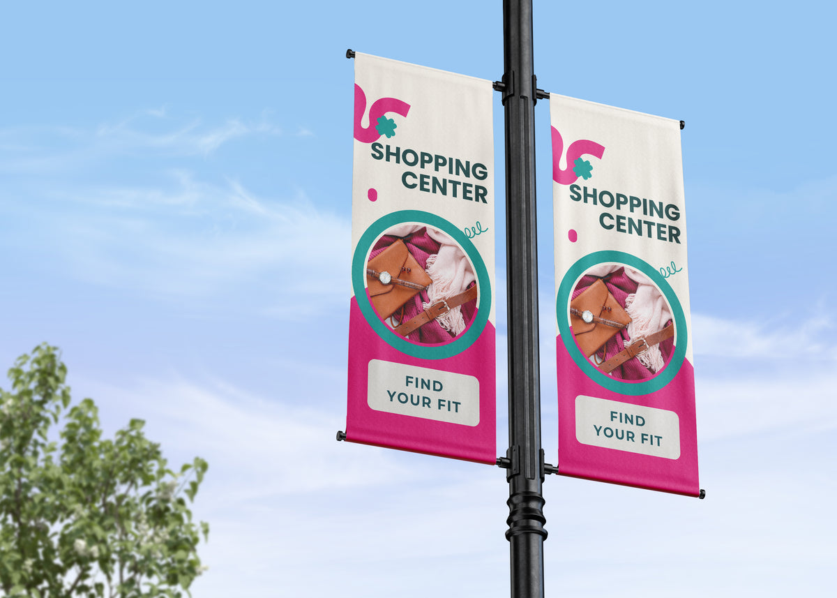 Two shopping center banners on a pole with a clear blue sky background