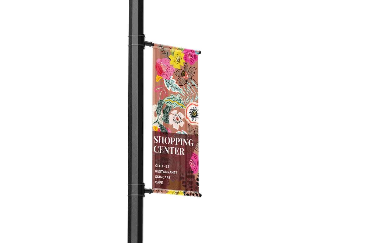 Colorful banner on a pole with shopping center text and floral design.