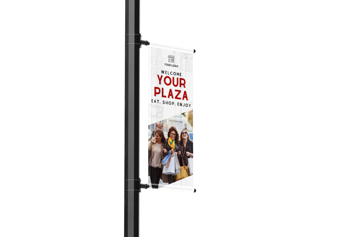 Banners on a pole with promotional text and images of people.