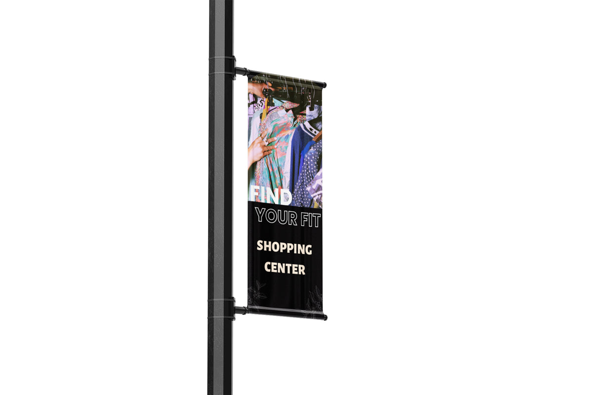Banners on a pole with promotional text and images of people shopping.